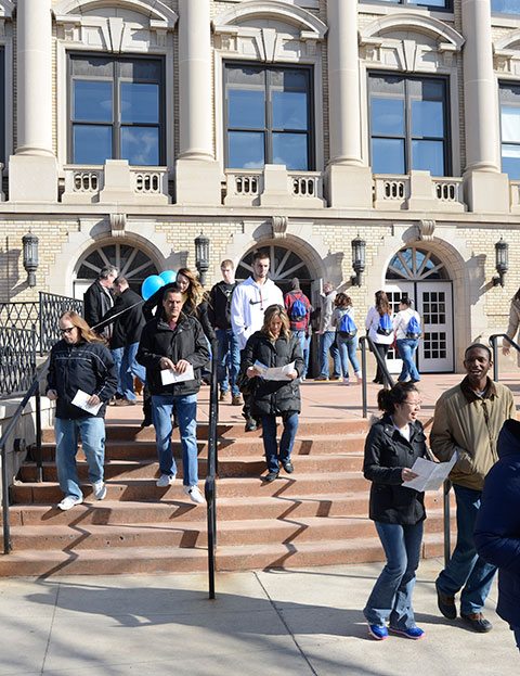 Armed with maps and girded with information from a just-ended overview session, Open House families exit the ACC for their next stop.