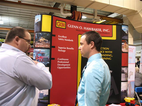 Andrew J. Powley, a heavy construction equipment: operator emphasis major from Dillburg, speaks with Bryan E. Frey from Glenn O. Hawbaker Inc.(who also serves on the Heavy Construction Equipment Operator Emphasis Advisory Committee).