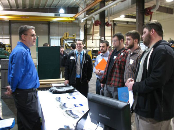 Diesel and heavy-equipment students stop by the Prevost booth at the Schneebeli Earth Science Center.