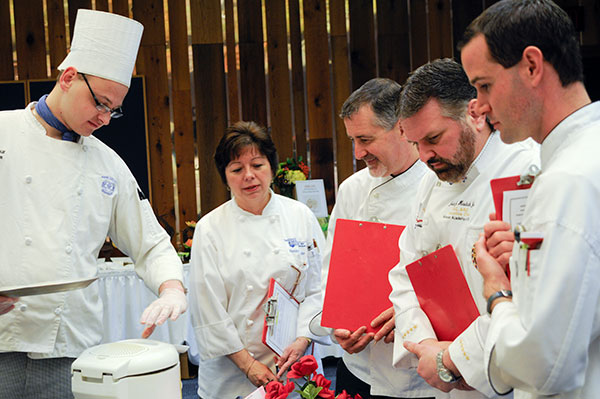 Arthur H. Byra, left, pulls fresh samples for guest judges, from left, Penny Shade, ’12, chef/supervisor at Penn State Schuylkill; Barry Crumlich, executive chef at the Pennsylvania governor’s mansion; John Hudak, of American Culinary Federation Professional Chefs of Northeastern Pennsylvania and Vanderlyn’s Restaurant; and Jeremiah Dick, chef/instructor in the State College Area School District.