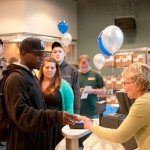 Joan M. Gilbert, head cashier/customer service liaison at The College Store, accommodates a long line of students.