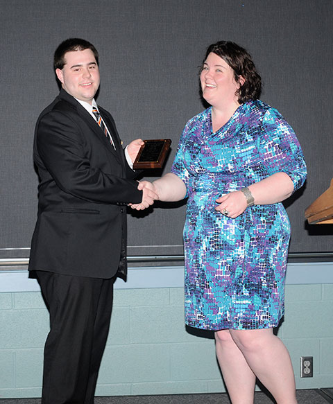 Phi Mu Delta’s Steven J. Kanaley, the Interfraternity Council’s vice president of chapter relations, is presented with the Greek of the Year Award by Sara R. Hillis, associate director of student activities. Phi Mu Delta swept the evening’s Greek honors, including the Academic Achievement Award for a collective 3.02 GPA among its members. 