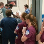Students observe the action in the “emergency room” at Student Health Services after a patient arrives by ambulance.