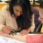 A quick study is Priya B. Patel, a nursing major from Morganville, N.J., applying henna to her friend, Kristen Sweeney.