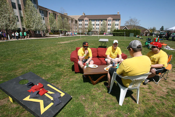 Sigma Nu fraternity members enjoy good eats and great seats in the center of the lawn while awaiting beanbag-tossing competitors. 