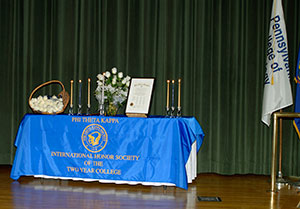 Candles and white roses add a distinctive ceremonial touch to the ACC stage.