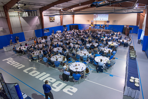 A standing-room-only crowd attends Coaches Caravan lunch in the college Field House.
