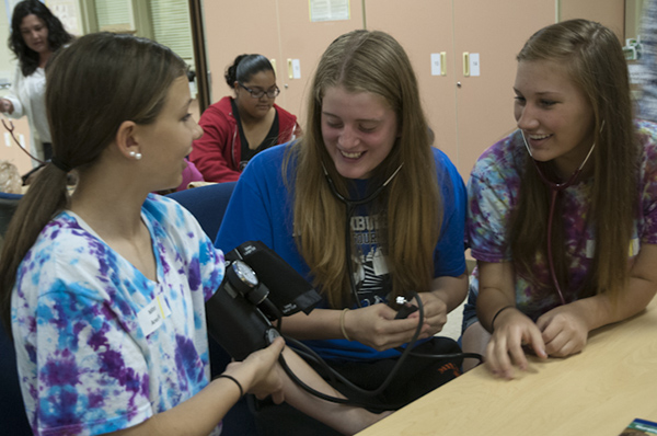 Students from Milton Area Middle School check one another’s blood pressure.