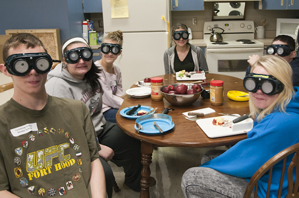 Students from Lycoming Valley Middle School try on a variety of goggles to experience vision problems.