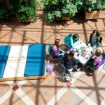 Even those who stayed indoors, like these patrons of the Breuder Advanced Technology and Health Sciences Center atrium, basked in the warmth of imminent summer.