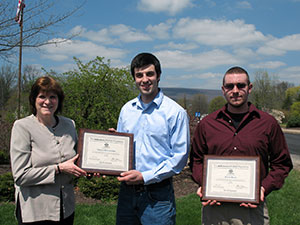 Plaques acknowledging scholarships from the mikeroweWORKS Foundation are presented to Penn College students Thomas M. DiGeronimo, Verona, N.J. (center), and Derek S. Black, of Trout Run, by Mary A. Sullivan, the college’s dean of natural resources management. (Photo by Carol A. Lugg, coordinator of matriculation and retention, School of Natural Resources Management)