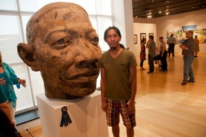 Artist Howard Tran with his burlap work titled “Hanh Trinh.” The piece was awarded first place in the “Art Alive!” Lycoming County Juried Art Exhibit at The Gallery at Penn College.
