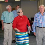 President Davie Jane Gilmour leads Stanley O. Ikenberry through the second floor of Madigan Library, accompanied by Robert E. Dunham (left background) and Paul L. Starkey.