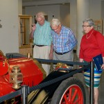 Admiring the 1909 Chalmers-Detroit roadster on display in the library are, from left, Dunham, Ikenberry, and President Gilmour and her husband Fred, an alumnus and college retiree.