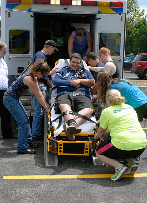 With make-believe maladies (except for the sling, which harbors a real-life injury), Nicholas J. Perri, a pre-emergency medical services student from Philadelphia, is wheeled aboard Susquehanna Regional EMS' bariatric ambulance.