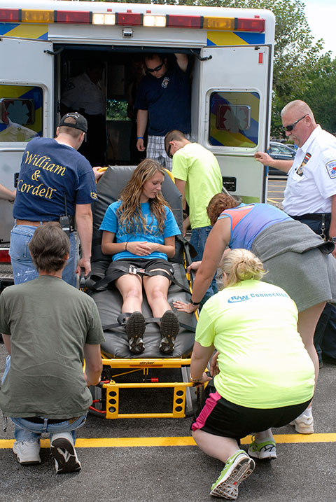 Kaitlyn M. Reedy, an emergency medical services major from Montgomery, takes her turn on the litter. At right is Susquehanna's Alfred P. Scott Jr., a 2008 graduate in Penn College's paramedic technician major. Assisting off-camera are Dayton J. Root, an emergency medical services student from Liberty (and a Susquehanna Regional EMS intern) and Tina Dymeck, an emergency medical technician. The visit was arranged by Jason P. Zielewicz, supervisor of prehospital services, a 2003 applied health studies graduate and part-time member of the college paramedic faculty.