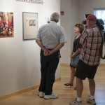 Mike Stevens visits college gallery for piece about Little League photo exhibit.