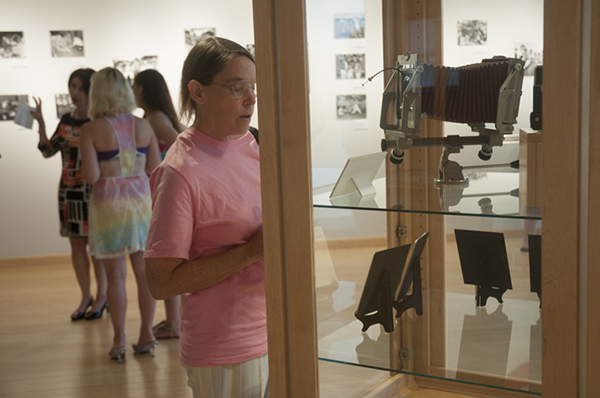 A visitor examines a display of some of Vannucci’s photo equipment.