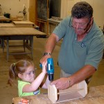 With the dean's assistance, each of the children donned the requisite eye protection and operated a power screwdriver. Morgan Hersh (whose father, Michael J., is assistant director of student activities for programming and Greek life) shows skill and determination in assembling a souvenir toolbox.