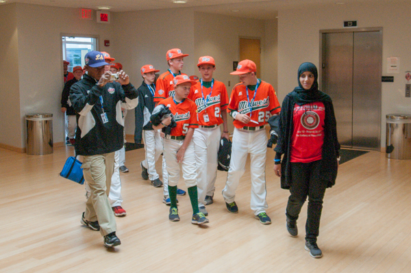 Midwest players, from Urbandale, Iowa, are guided to the gallery by student helper Hanan Almuhathab.