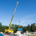 A 35-ton crane maneuvers equipment into place.