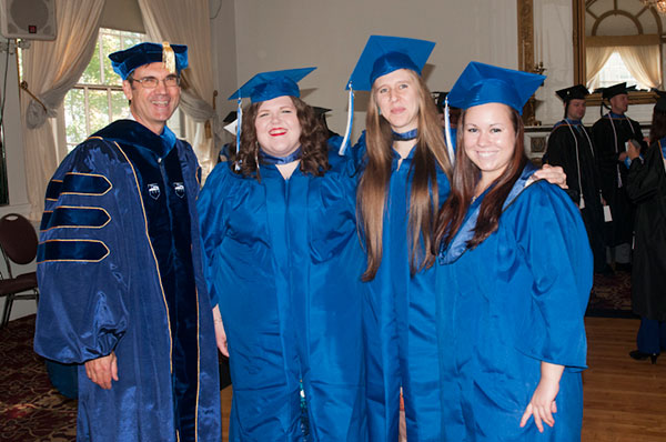 Baking and pastry arts majors Cameron J. Stewart, Amanda J. Bickel and Danica C. Mazzotta gather with their dean, Fred W. Becker.