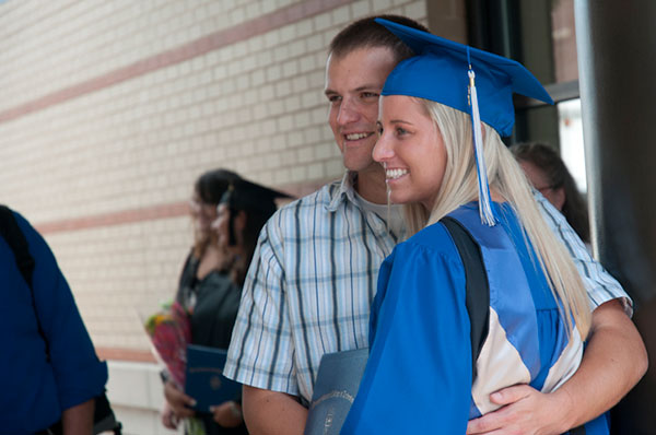 A graduate poses with loved ones to commemorate the day.