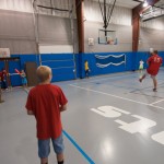 "Play ball!" The game begins in a traditional "windup" to the college's youth camp.