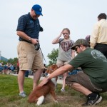 Elliott Strickland, chief student affairs officer – with daughter Emma and "Rusty," their Brittany – engages a student at Wednesday's event.