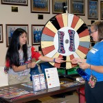 Student April M. Tucker collects her winnings from a spin of the Williamsport Crosscutters prize wheel.