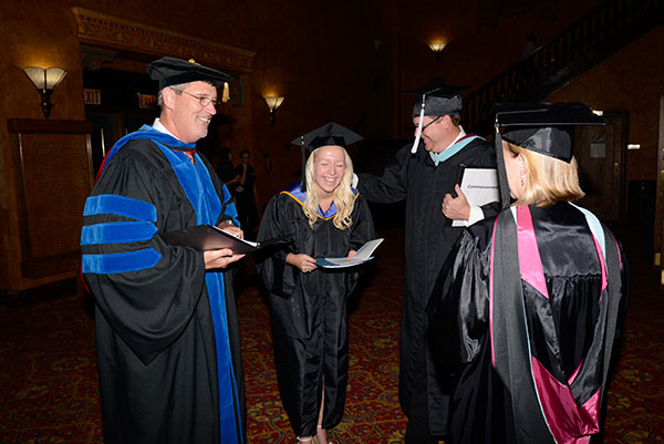 It's all smiles as the student speaker unwinds with (from left) Paul L. Starkey, vice president for academic affairs and provost; Elliott Strickland, chief student affairs officer; and Carolyn R. Strickland, assistant vice president for academic services.