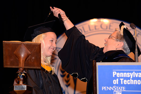 The president turns the tassel of Katherine P. Wylezik ...