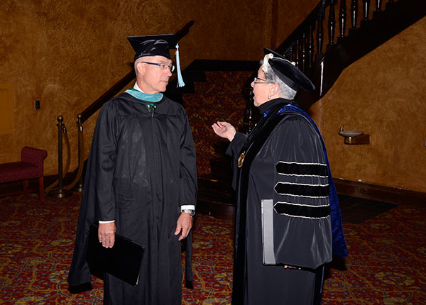 President Gilmour talks with Steven P. Johnson, a member of the college's board of directors.