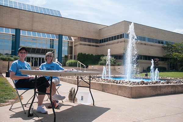 Anne K. Soucy, assistant dean of construction and design technologies (left), and Counseling Services' Mary Lee L. Kelly staff an information table outside the Breuder Advanced Technology and Health Sciences Center.