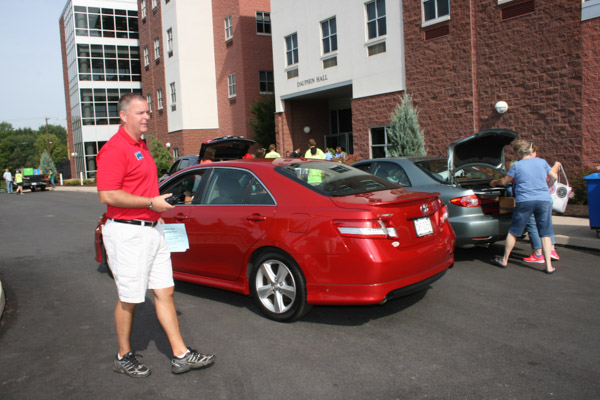 Jon D. Wescott, the college's new director of residence life, directs traffic.
