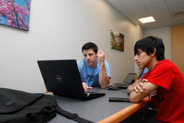 Joshua P. Boley, a freshman in welding technology from  Fort Lee, N.J., gets his laptop set up with Gallahad E. Mallery, assistant director of computing services. 