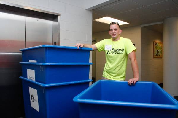 Volunteer Mark W. Campbell, a senior in automotive technology management from Leesburg, Va., takes a deserved rest while waiting for the elevator.
