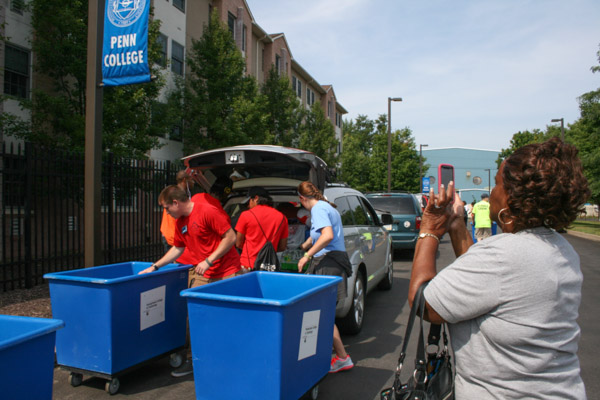 An excited Grandma captures the action with her cell phone. 