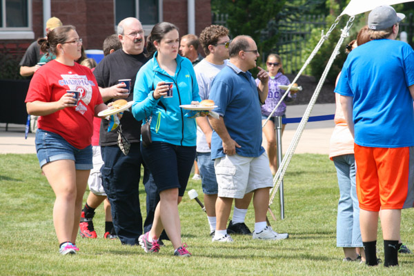 Refreshments and food in hand, families seek out a seat under the tents. 