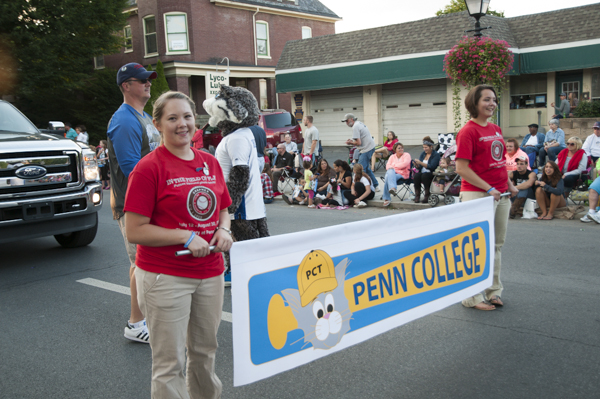 Surgical technology student Heather R. Krepps and baking and pastry arts major Samantha-Jo Bradley lead the Penn College parade entry. 