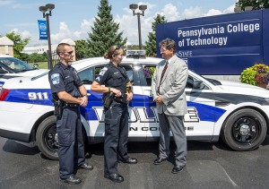 Penn College Police Chief Chris Miller (right) talks with Adam J. Haffley, police officer, and Jen J. Bowers, police officer/investigator, near the main campus entrance off Maynard Street.