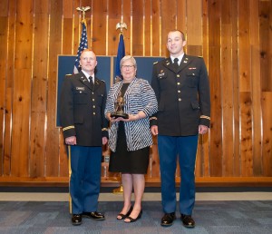 Recent graduates Brian Arnold, of Chadds Ford (left), and James D. Fortenberry, of Lemoyne, are joined by Penn College President Davie Jane Gilmour during an Aug. 17 commissioning ceremony. The president was presented with a statue honoring her support for the Army ROTC program on campus.