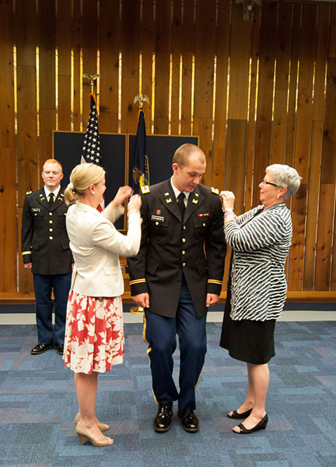 With classmate Brian Arnold standing by, James D. Fortenberry Jr. is pinned by Penn College President Davie Jane Gilmour (right) and Carolyn R. Strickland, assistant vice president for academic services, at a <a href=