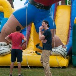 ... while others show their obvious amusement at friends exploring the inflatable obstacle course.