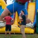 ... while others show their obvious amusement at friends exploring the inflatable obstacle course.