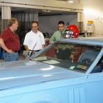 From left, Pat Dixon, Christopher H. Van Stavoren and Greg Hayes outline the work to be done on a donated Lincoln.