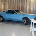 Students have already removed some of the chrome in preparation for repainting; the nearby Millionaires football helmet offers a preview of the car's eventual color.