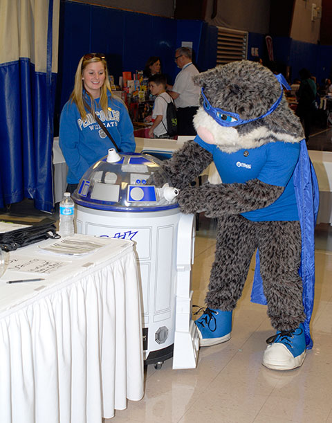 Supervised by Blair E. Smith, the college library's support services assistant, the Wildcat stirs up the raffle entries.
