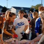 The gloved hands of intramural assistant Timothy J. Stasulli, an information technology: information assurance and security concentration major from Hamburg, help students bag their shirts for safe transport.