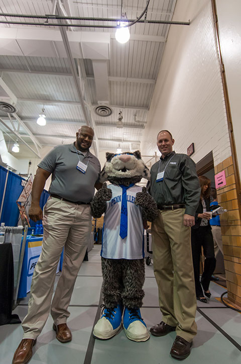 Graduates tower over the college's nonetheless-formidable mascot. Joining the Wildcat are Maurice L. Freeman (left), who earned two HVAC-related degrees in 2002 and 2003, and Kevin L. Imes, a 2007 construction management alumnus. Freeman was here with B.C. Freeman Mechanical and Electrical Inc., State College; Imes is employed by Wohlsen Construction in Lancaster.